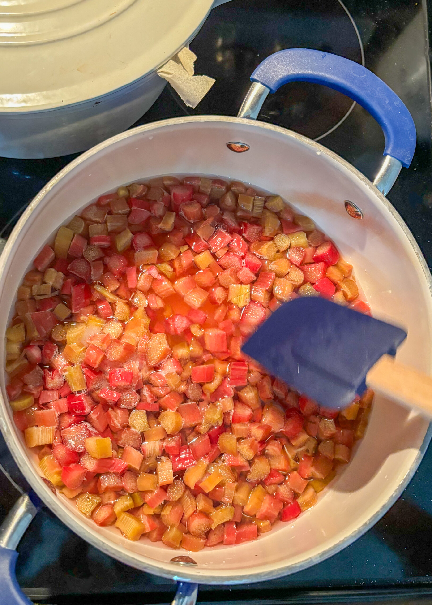 Cooking rhubarb and sugar and bringing to a boil