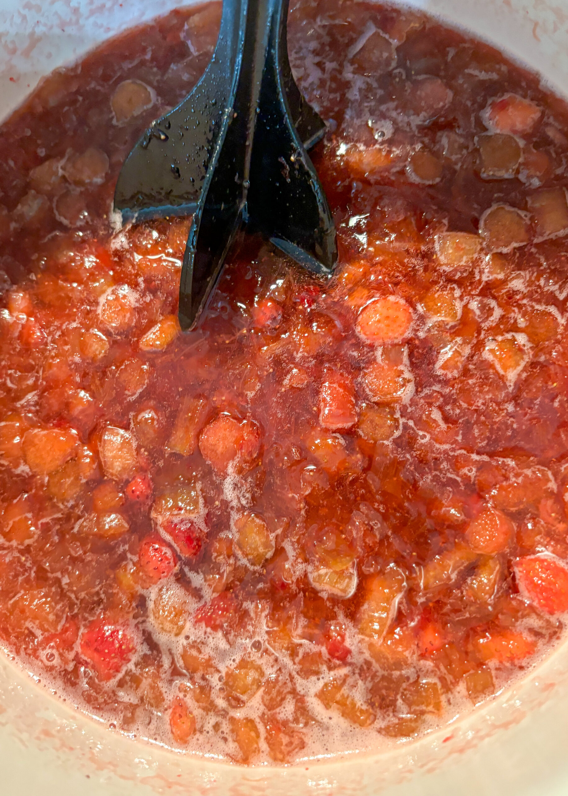 Strawberries added to rhubarb and sugar