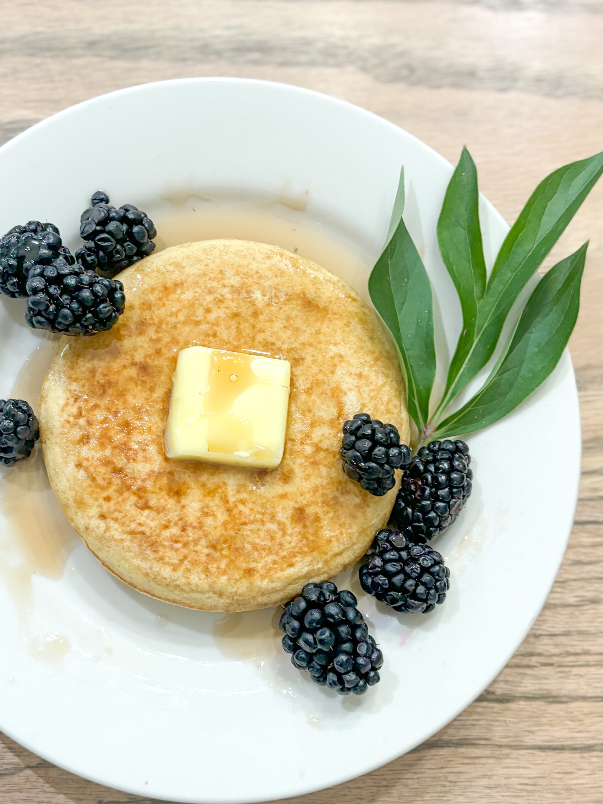 Sourdough Pancake with garnish, butter, and berries