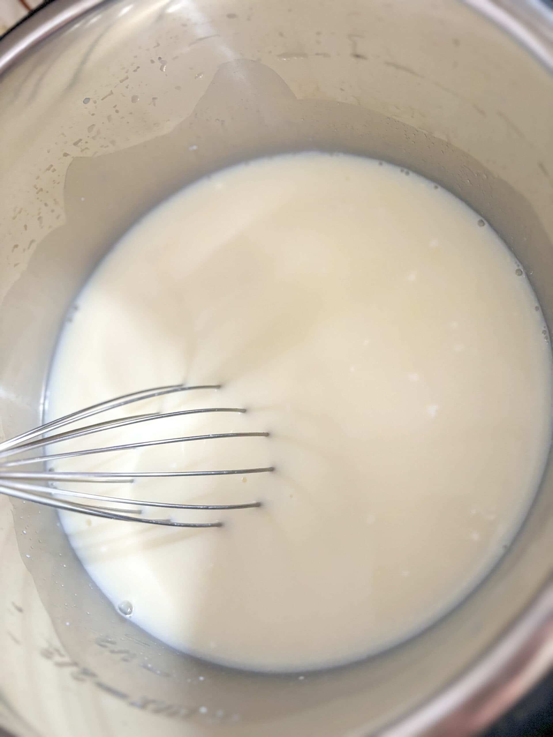 Mixing in the Greek yogurt starter culture with the raw milk