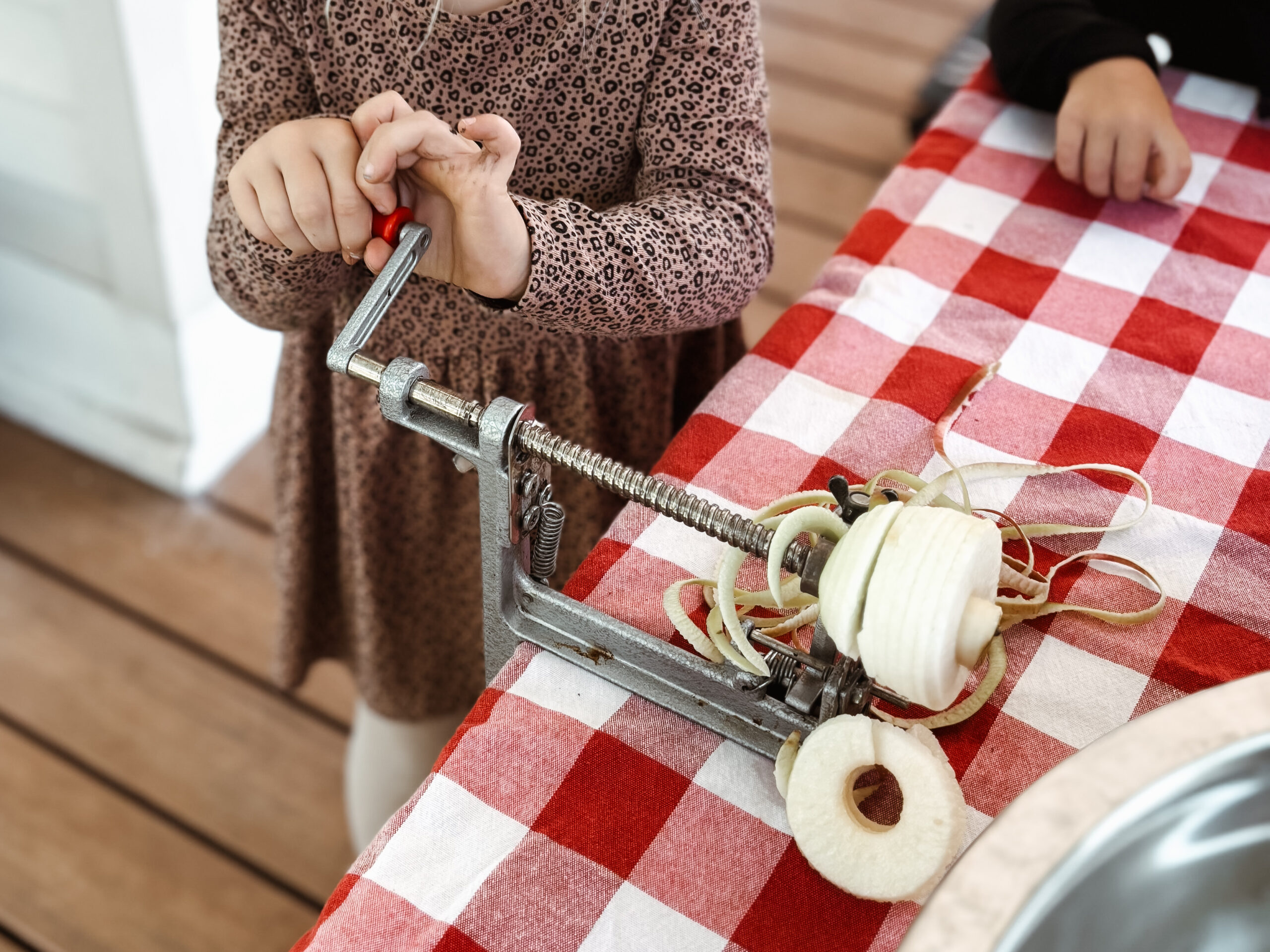 Gertie peeling, coring, and slicing the fresh apples for the homemade apple pie filling recipe for canning