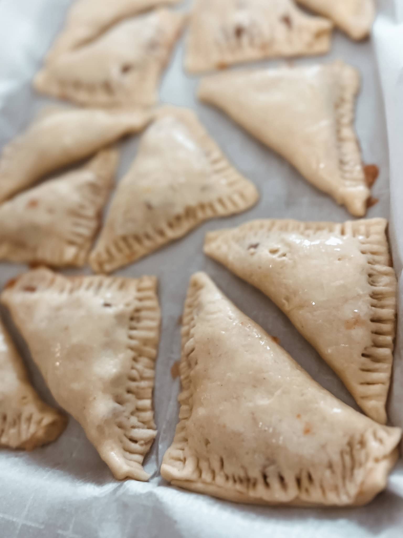 Sourdough discard apple turnovers step 6, fold over the pie crust to form a triangle and seal the edges closed with a fork