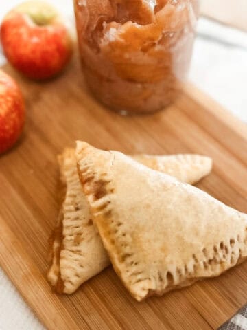 sourdough discard apple turnover finished featured image with apples on a cutting board