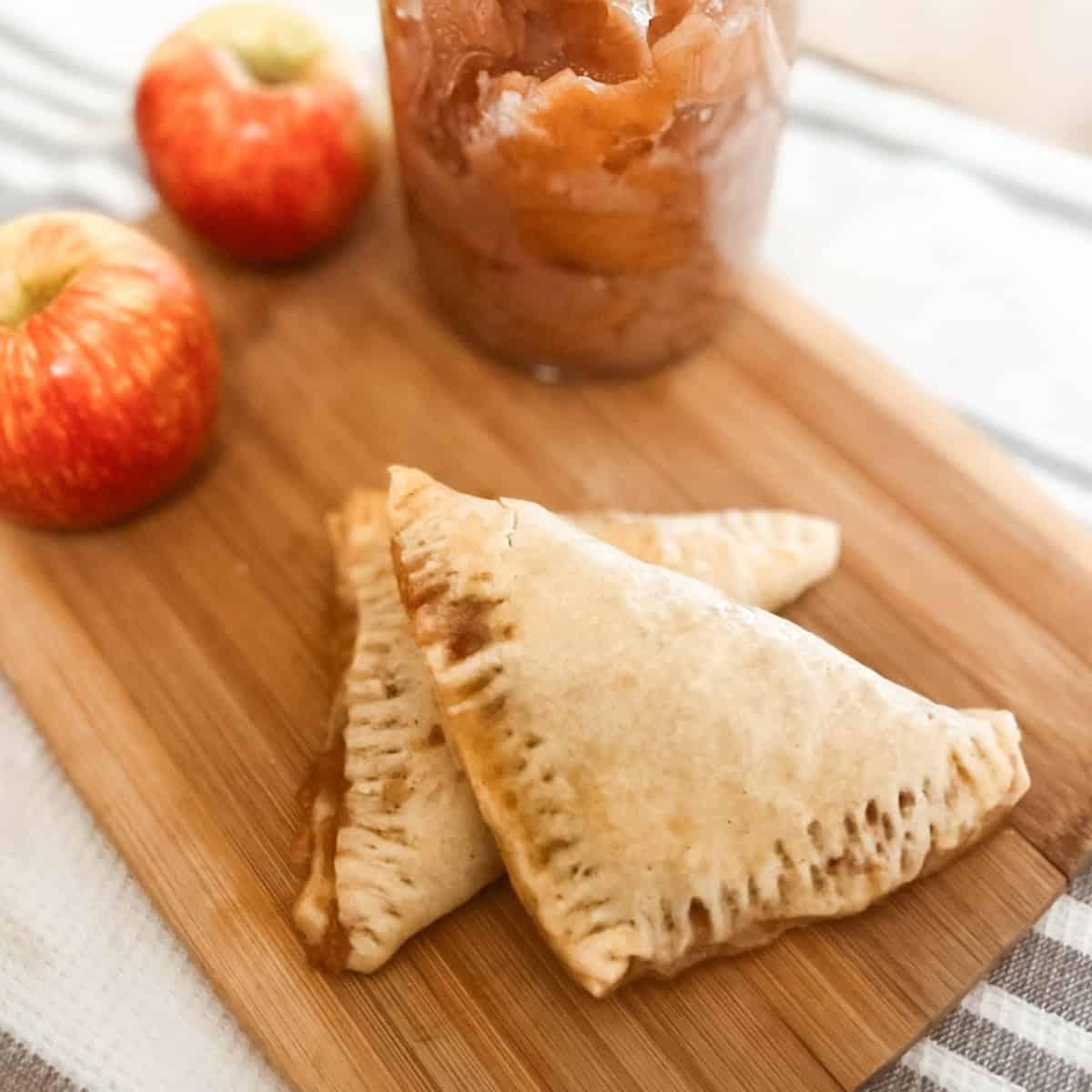 sourdough discard apple turnover finished featured image with apples on a cutting board