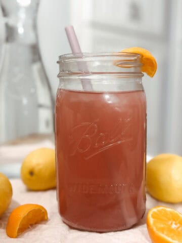 featured image for homemade electrolyte powder drink in a mason jar with oranges and lemons