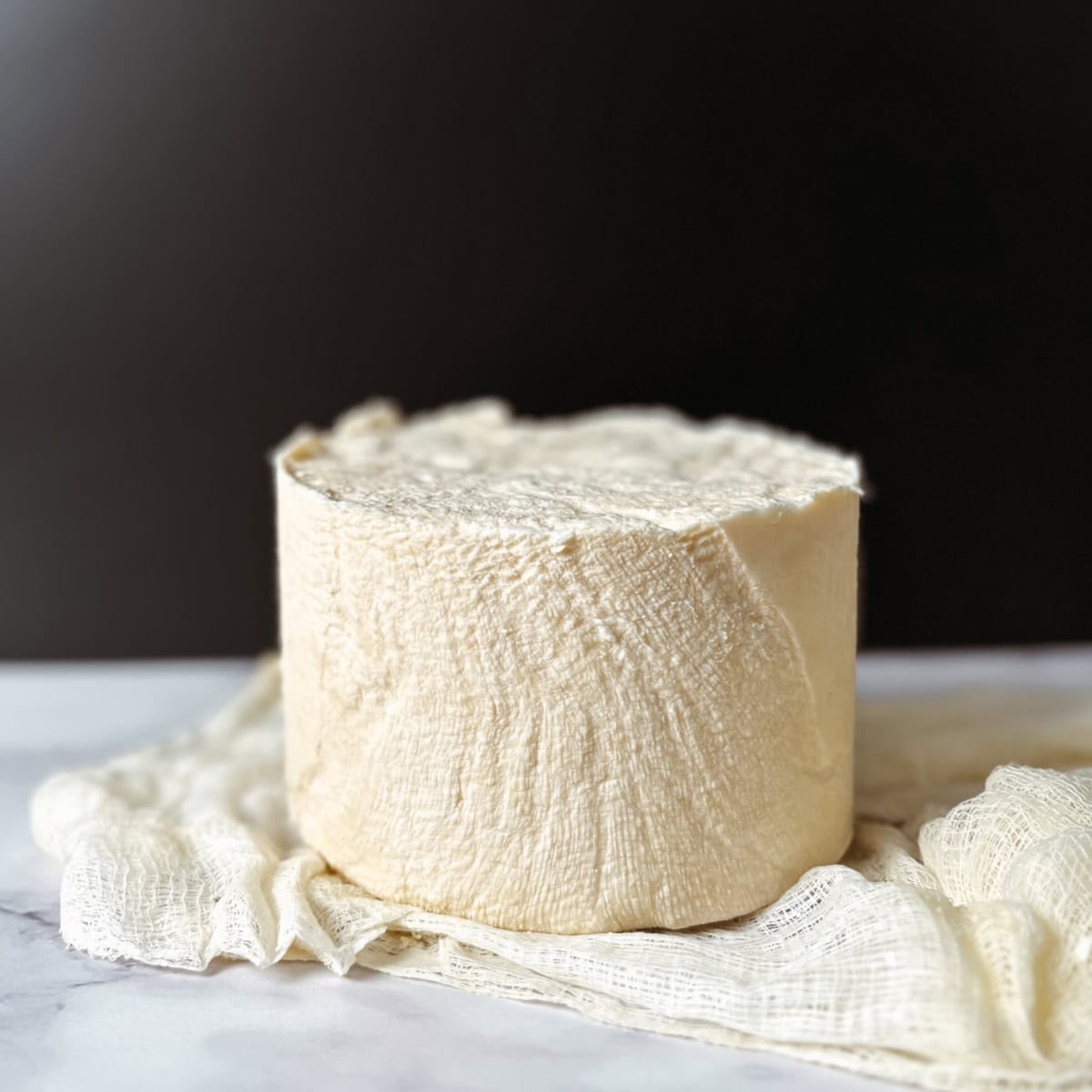 Raw milk cheddar cheese wheel featured photo